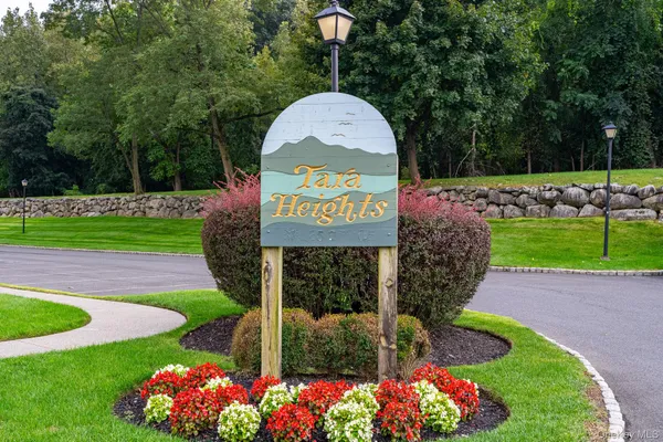 a sign that is sitting in front of flowers