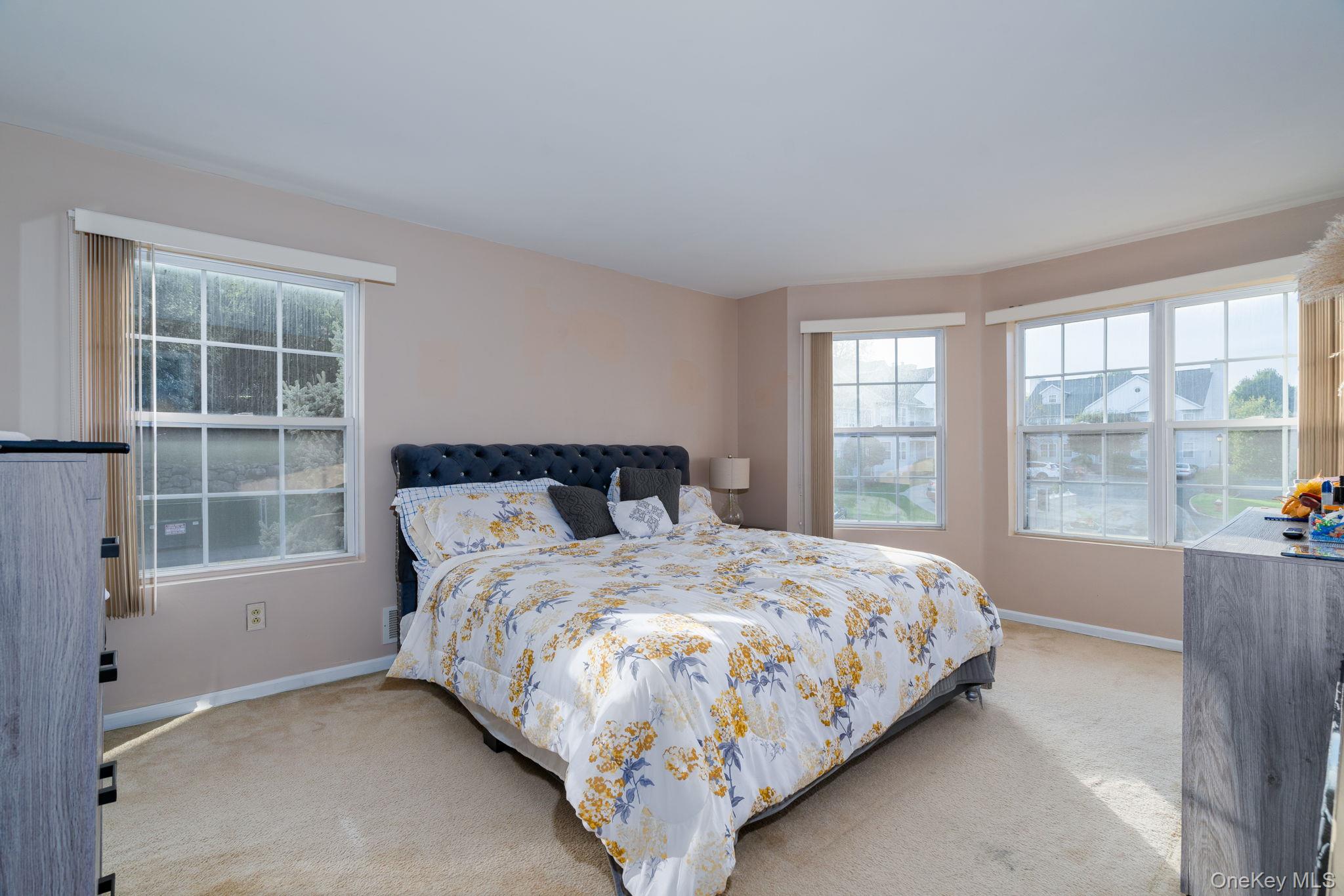 205 Ramapo Road, Unit H Garnerville, NY 10923 - Photo 12 of 31 a bed sitting in a bedroom next to a window