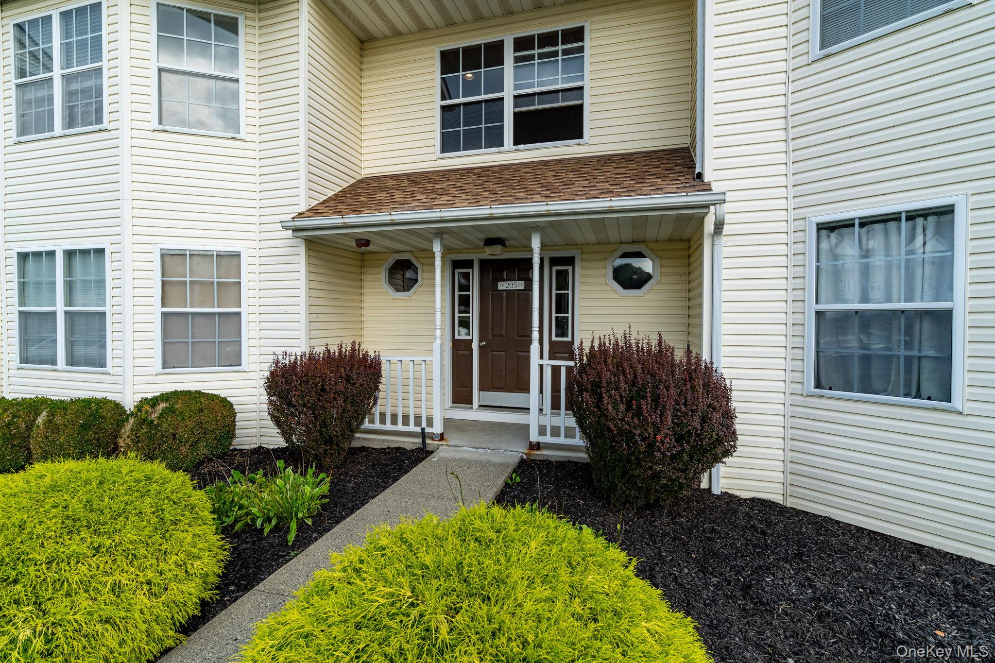 205 Ramapo Road, Unit H Garnerville, NY 10923 - Photo 2 of 31 a view of a house with a yard and plants