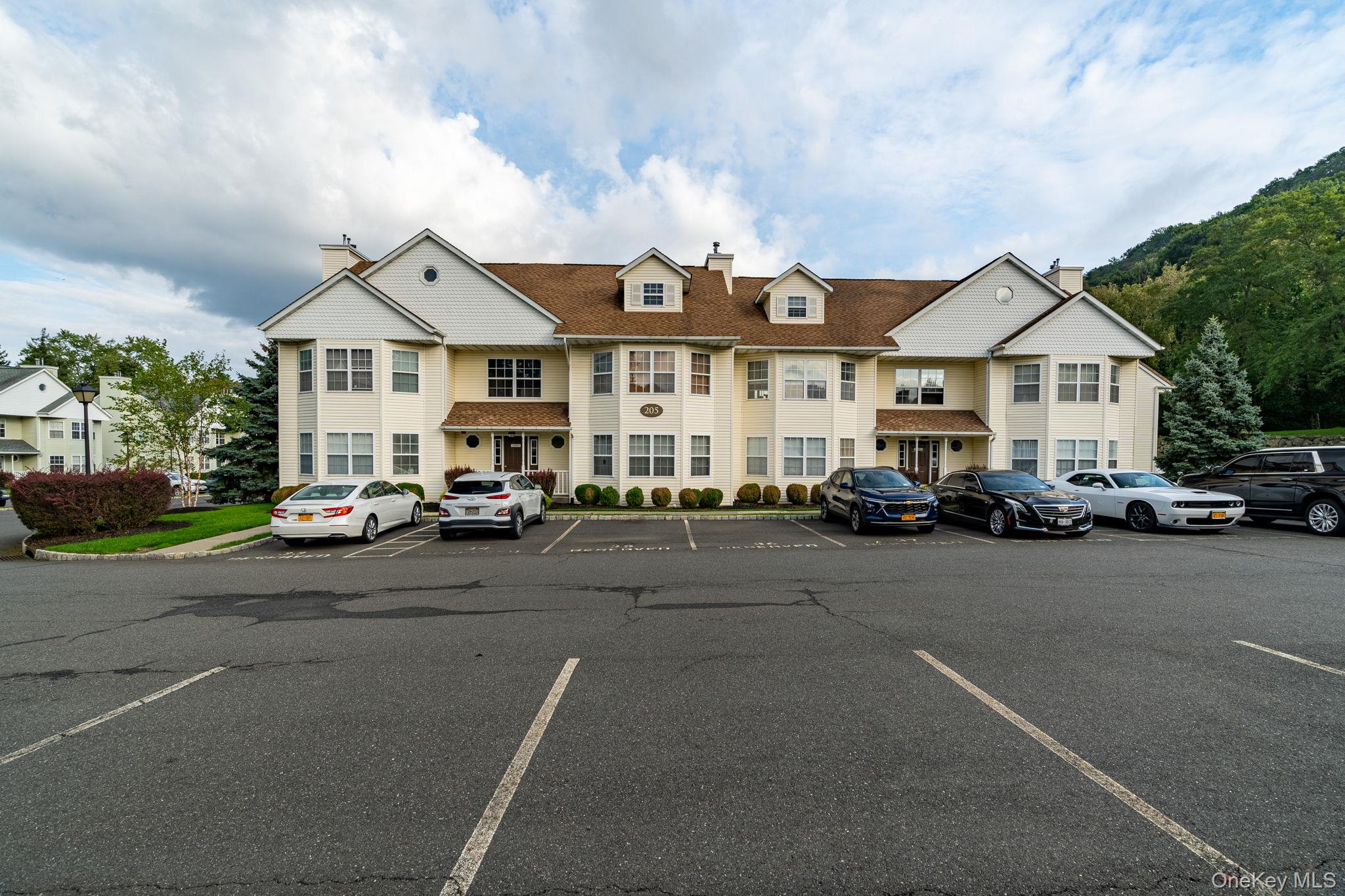 205 Ramapo Road, Unit H Garnerville, NY 10923 - Photo 30 of 31 a city street lined with buildings and cars