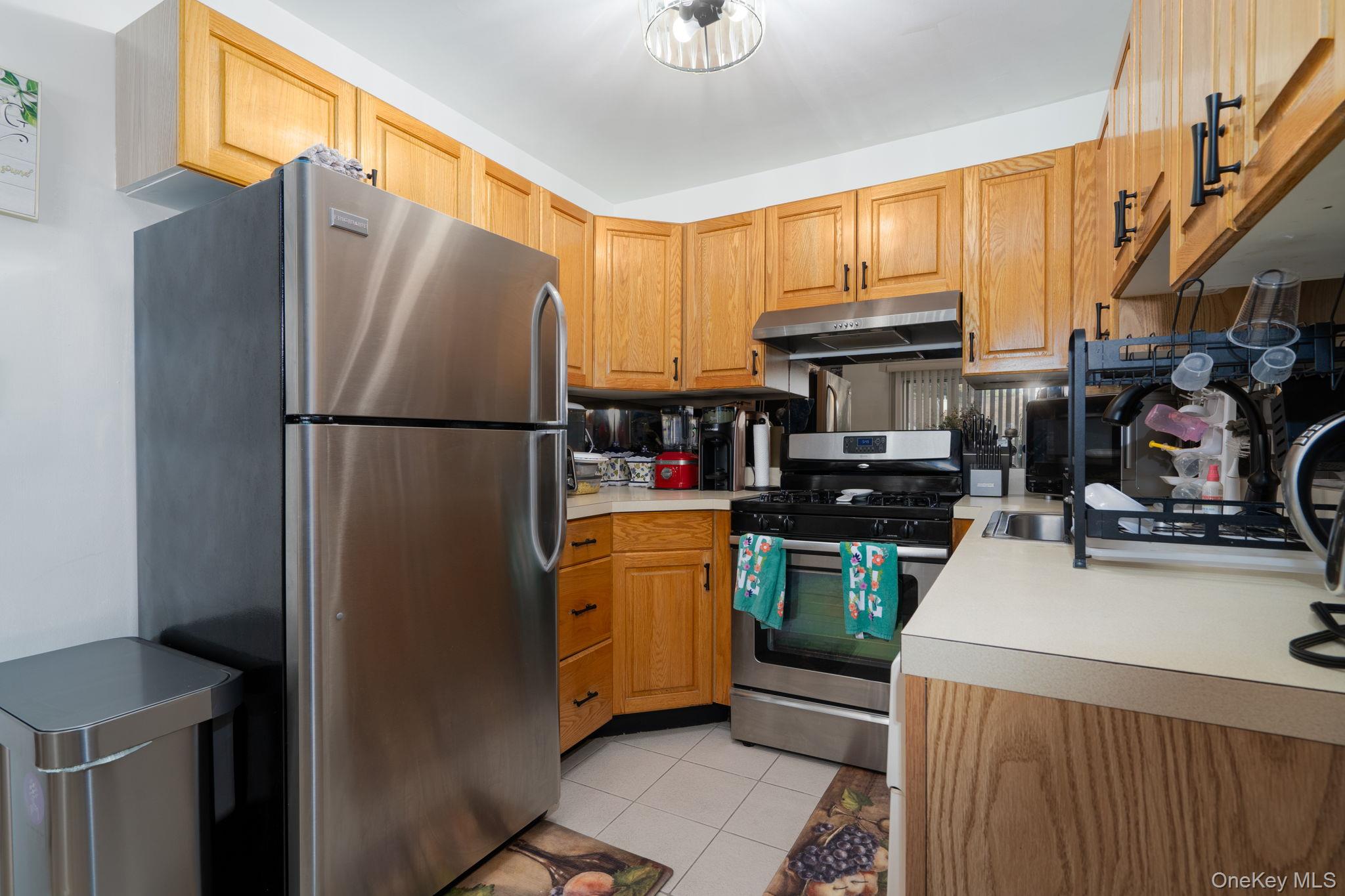 205 Ramapo Road, Unit H Garnerville, NY 10923 - Photo 7 of 31 a kitchen with stainless steel appliances granite countertop a refrigerator stove and a sink