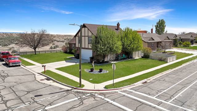 1716 Sagewood Road Price, UT 84501 - Photo 59 of 73 Tudor home featuring an attached garage, stucco siding, a residential view, and concrete driveway