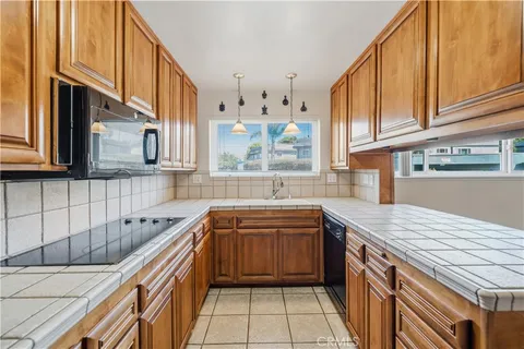 a kitchen with stainless steel appliances granite countertop a sink a stove and cabinets
