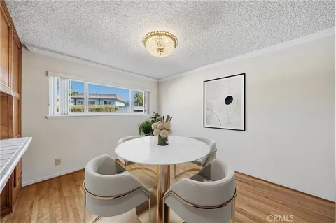 a dining room with furniture and wooden floor
