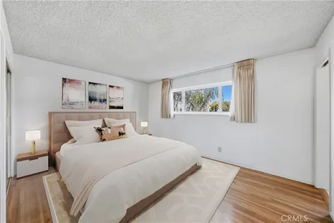 a bedroom with a large bed and a window