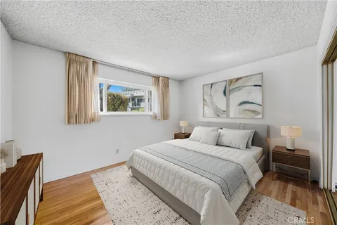 a bedroom with a large bed and a couch