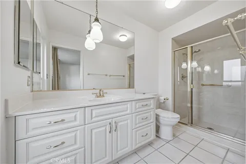a spacious bathroom with a double vanity sink mirror and toilet