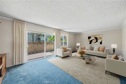 a living room with furniture and a glass door