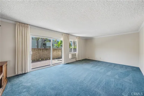 a view of an empty room with glass door
