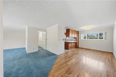 a view of a kitchen with wooden floor and electronic appliances