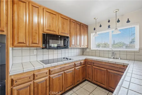 a kitchen with a sink cabinets and window