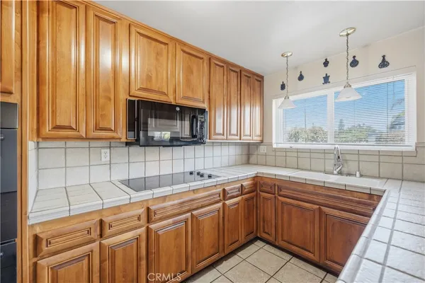 a kitchen with a sink cabinets and window