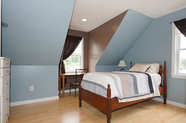 237 Acropolis Road Lowell, MA 01854 - Photo 12 of 22 a bed sitting in a room next to a window