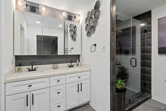 a bathroom with a double vanity sink and mirror