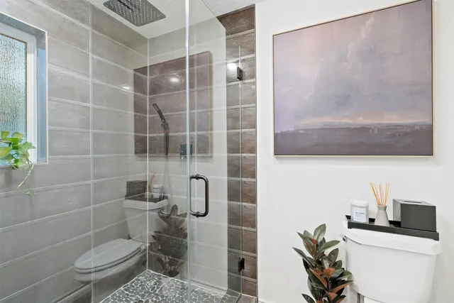 a bathroom with a toilet sink and shower