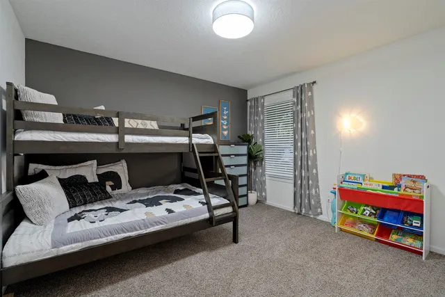 a bedroom with furniture and a book shelf