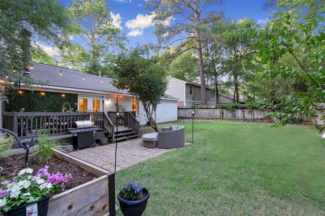 a view of a backyard with plants and a garden