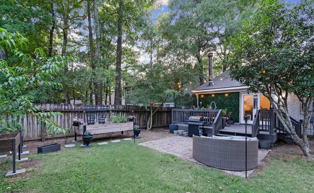 a view of backyard with table and chairs a fire pit