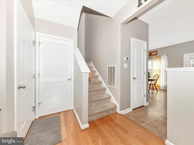 a view of a hallway with wooden floor and entryway