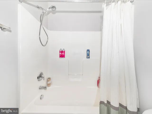 a bathroom with a shower and a shower