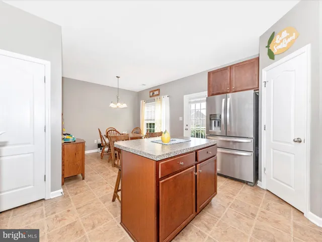 a kitchen with a stove top oven and refrigerator