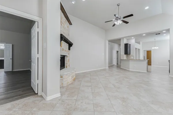 a view of an empty room with a fireplace