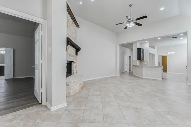 a view of an empty room with a fireplace
