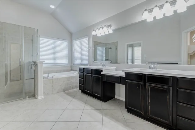 an empty room with wooden floor ceiling fan and windows