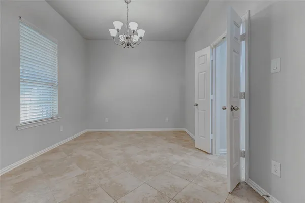 a view of a hallway with wooden floor and a livingroom