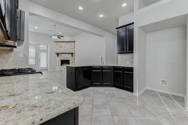 a kitchen with granite countertop stainless steel appliances and cabinets
