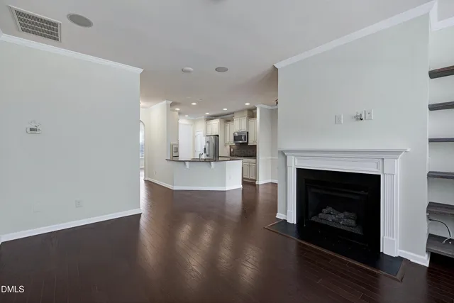 a view of a livingroom with an empty space and a fireplace