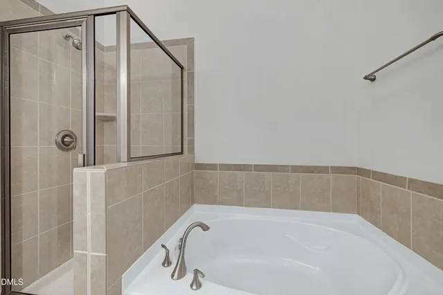 a spacious bathroom with a double vanity sink a mirror and a shower