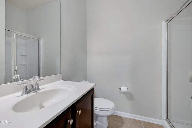 a bathroom with a glass shower door