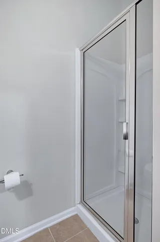 a bathroom with a glass shower door