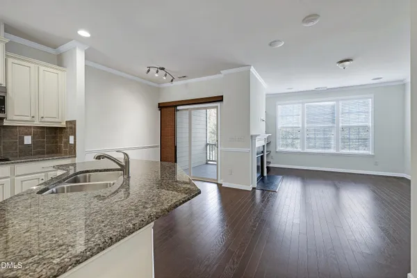 a view of a hallway with wooden floor and stairs