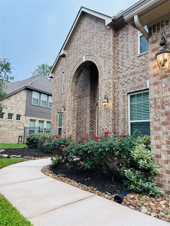 a front view of a house with yard and green space