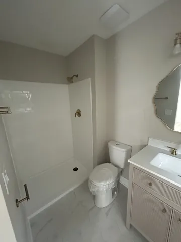 a white toilet sitting next to a bathroom sink