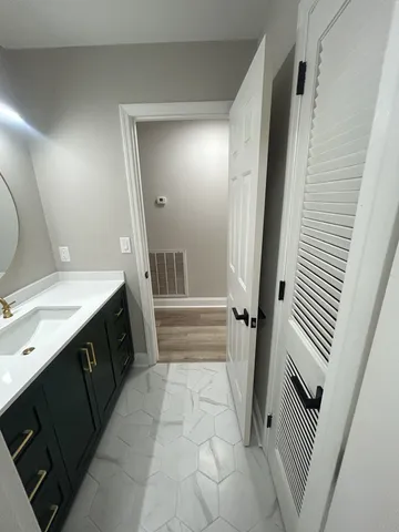 a bathroom with a sink and a mirror