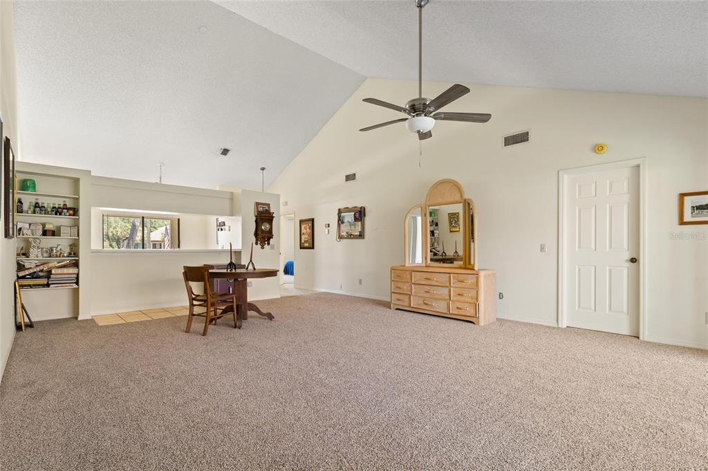 1801 East Lake Road South, Unit 4E Palm Harbor, FL 34685 - Photo 10 of 26 a view of a livingroom with furniture and a ceiling fan