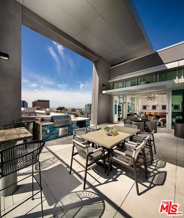 707 East Ocean Boulevard, Unit PH1704 Long Beach, CA 90802 - Photo 15 of 21 a view of a dinning table and chairs in the patio