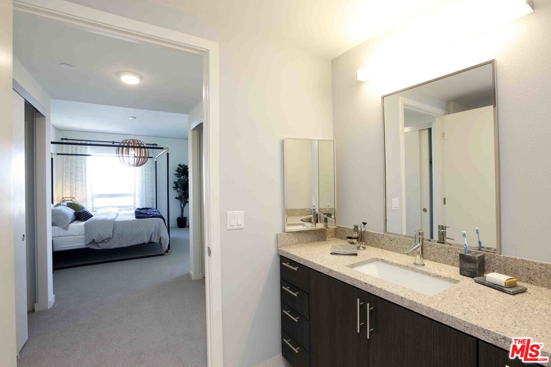 707 East Ocean Boulevard, Unit PH1704 Long Beach, CA 90802 - Photo 3 of 21 a en suite bathroom with a sink and a mirror