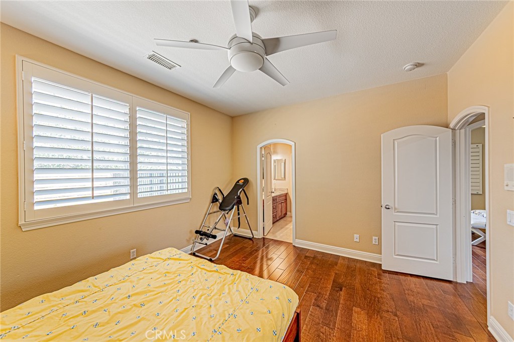 4088 Shady Ridge Circle Corona, CA 92881 - Photo 15 of 47 a room with a bed and wooden floor