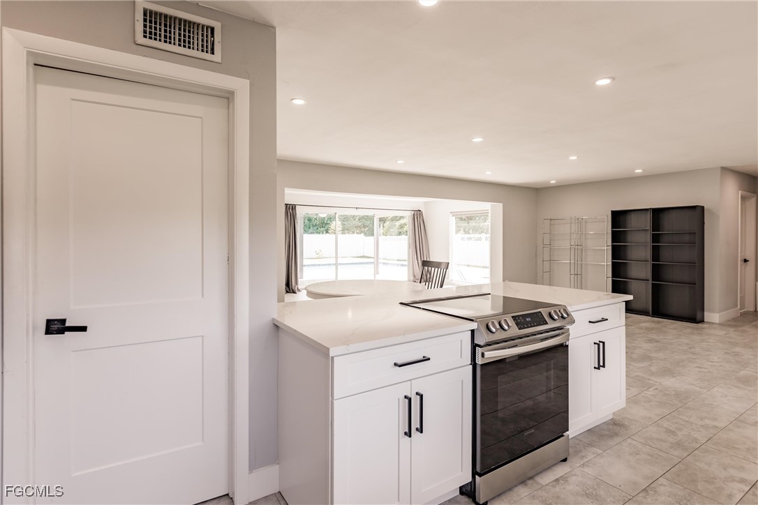 905 Dean Way Fort Myers, FL 33919 - Photo 12 of 43 a kitchen with a stove and a refrigerator