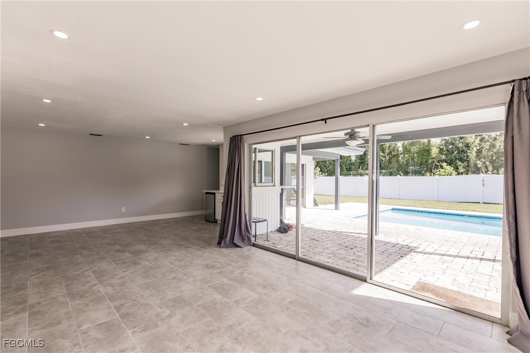 905 Dean Way Fort Myers, FL 33919 - Photo 17 of 43 a view of an empty room with a sliding door