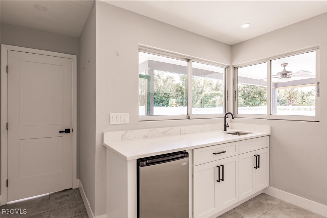 905 Dean Way Fort Myers, FL 33919 - Photo 20 of 43 a kitchen with appliances cabinets and a window