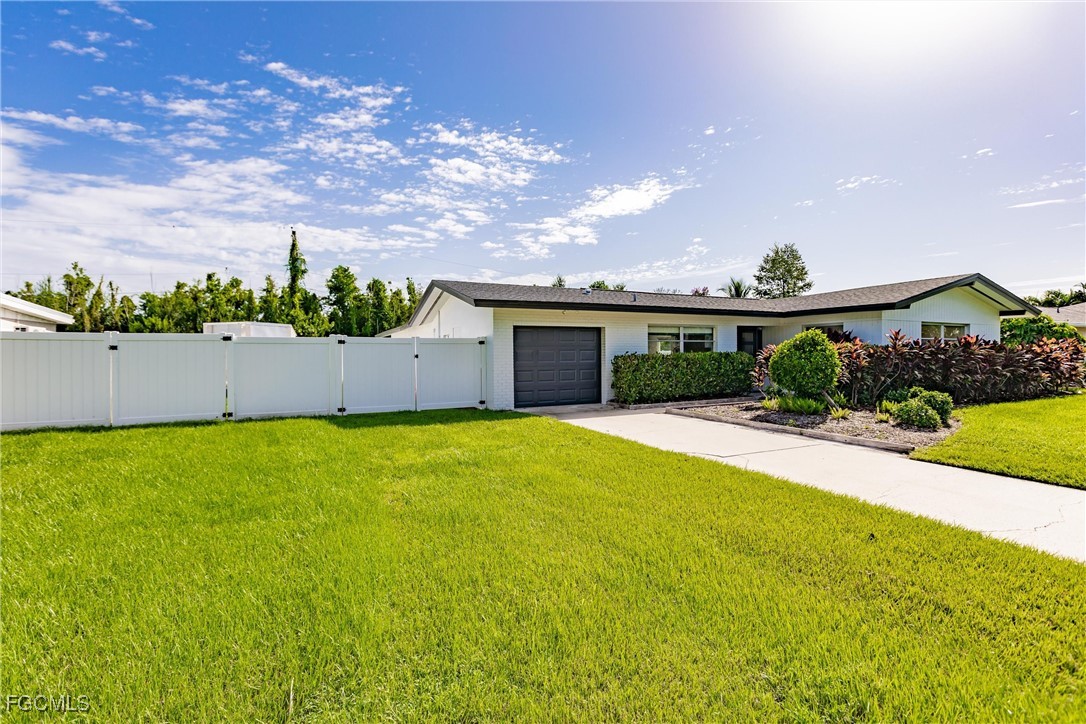 905 Dean Way Fort Myers, FL 33919 - Photo 2 of 43 a view of an house with backyard and a garden