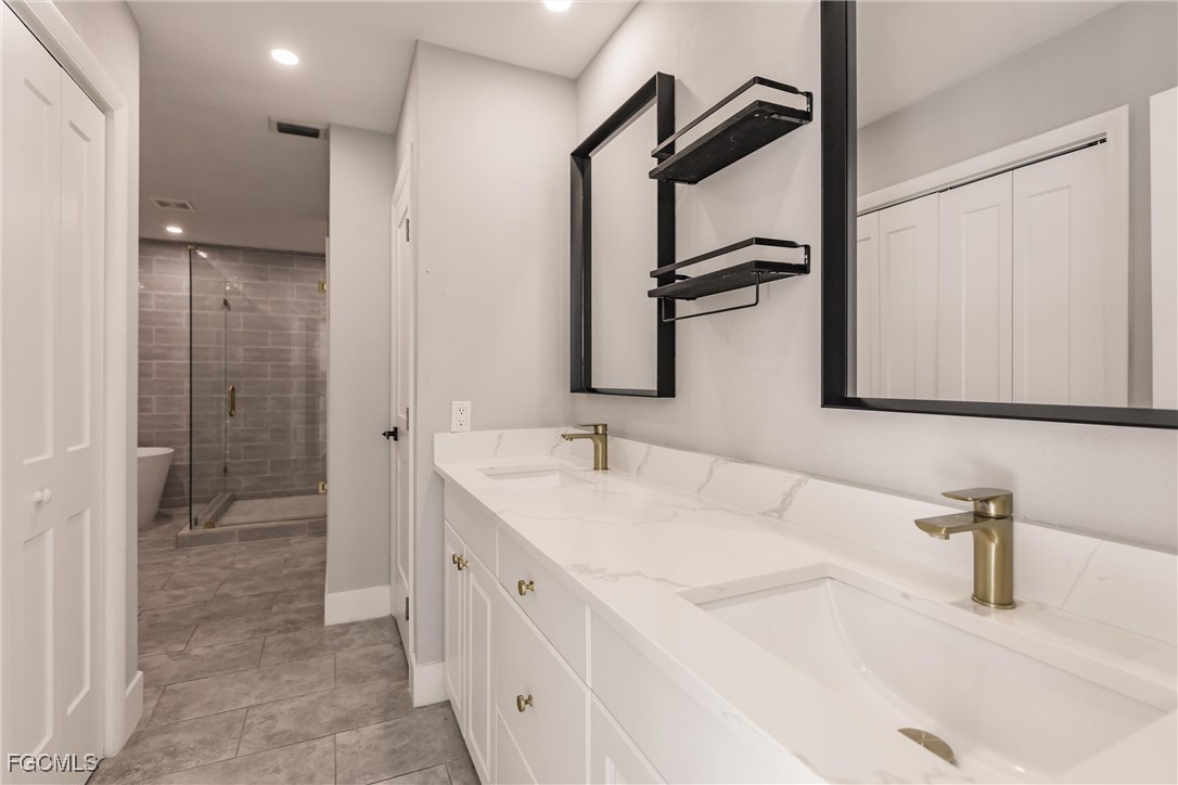 905 Dean Way Fort Myers, FL 33919 - Photo 24 of 43 a bathroom with a double vanity sink and a mirror