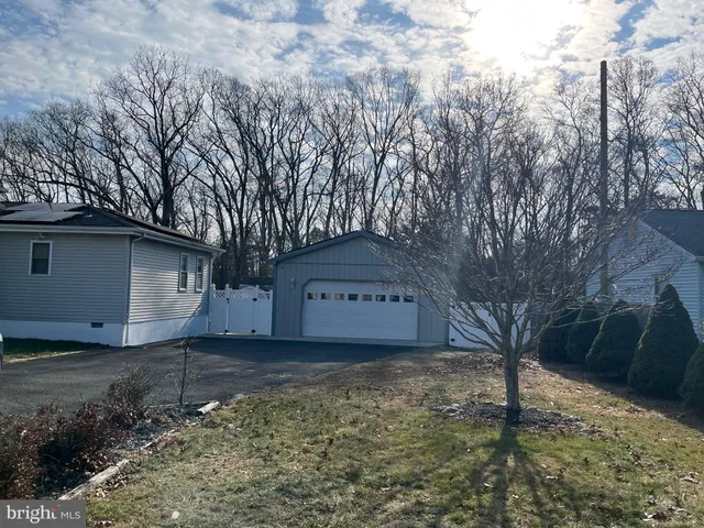 a view of a house with a large tree