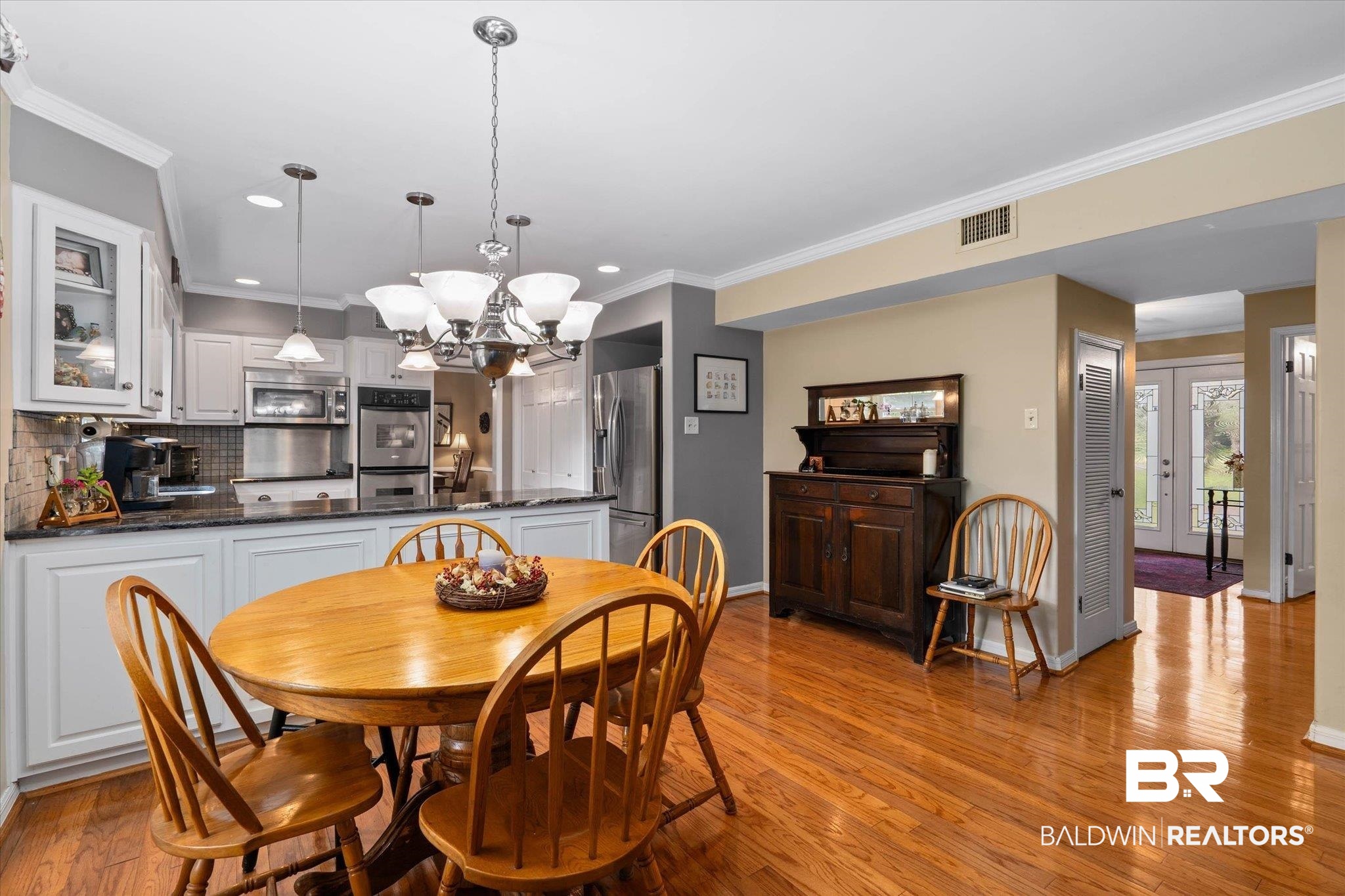 559 East Cumberland Road Mobile, AL 36608 - Photo 13 of 48 Dining area with ornamental molding, hanging lights, and light wood-style flooring