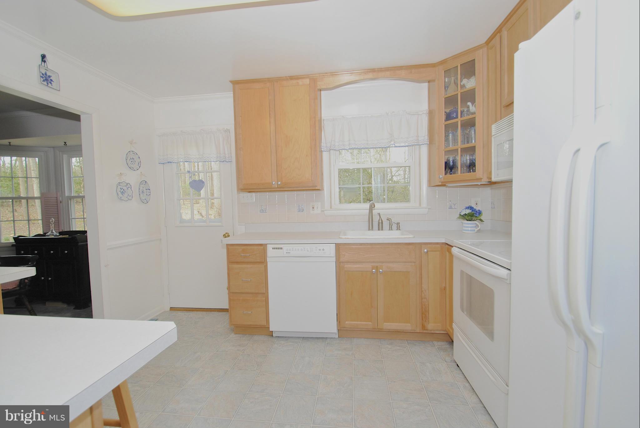 985 Chesterfield Road Annapolis, MD 21401 - Photo 11 of 30 a kitchen with white cabinets and white appliances